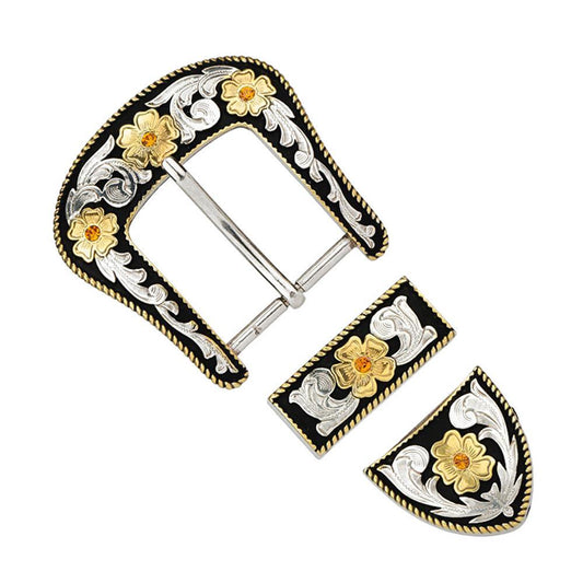 Verzierte Gürtelschnalle aus Metall mit Blumenmuster in Gold und Silber auf schwarzem Grund